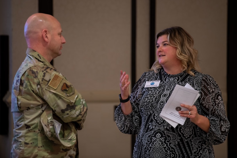 U.S. Air Force Chief Master Sgt. David Snarr, 628th Air Base Wing command chief, and Jamie McCarthy, Joint Base Charleston honorary commander, converse during an honorary commander induction ceremony on Joint Base Charleston, South Carolina, Nov. 2, 2023.