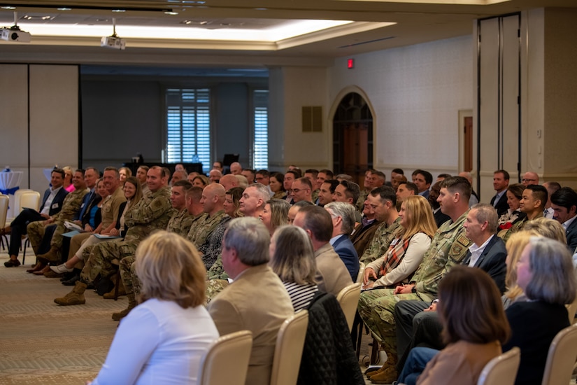 U.S. service members and civic leaders listen to a speech during an honorary commander induction ceremony on Joint Base Charleston, South Carolina, Nov. 2, 2023.