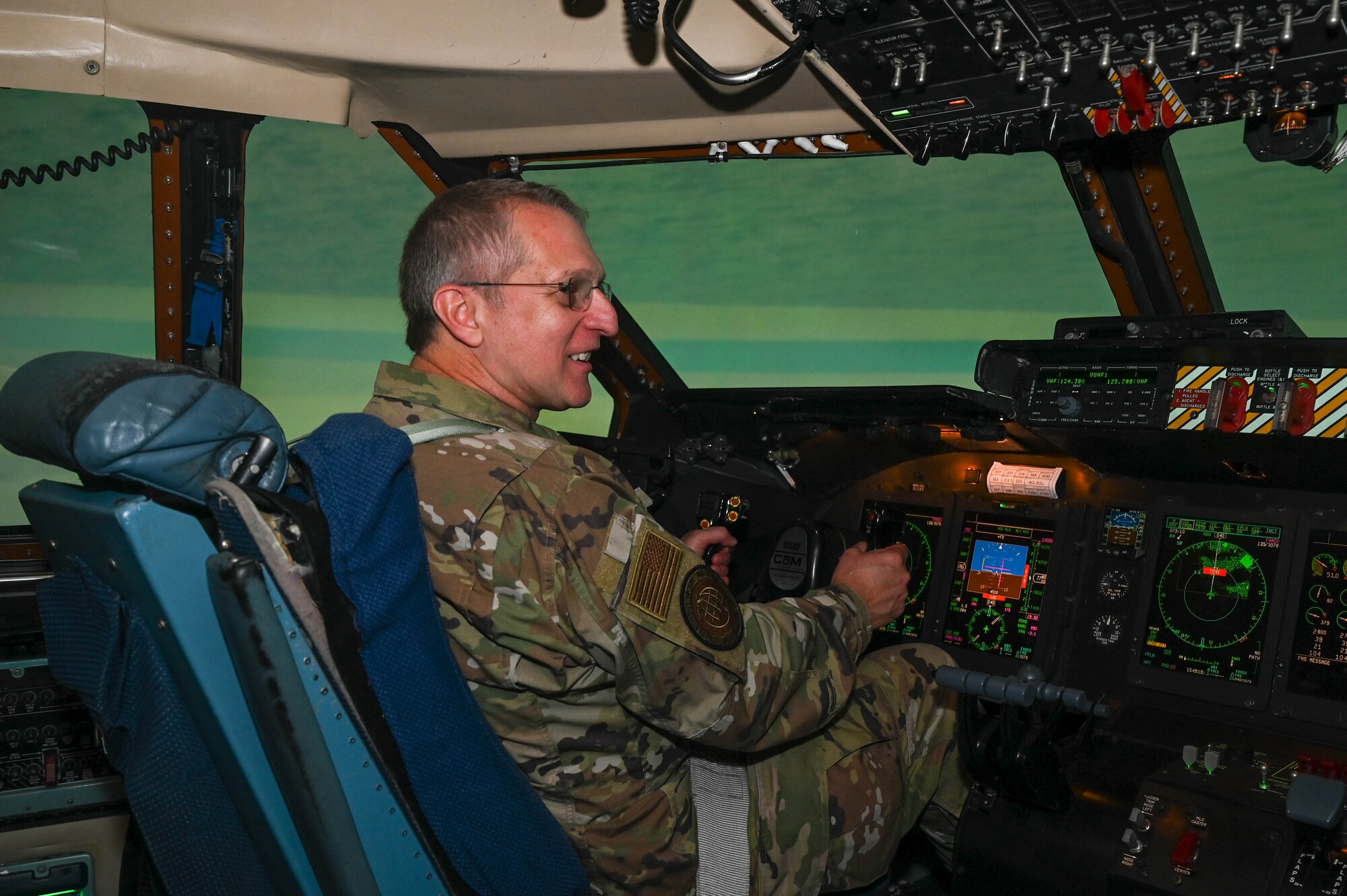 Maj. Gen. John Bartrum, Mobilization Assistant to the Surgeon General of the Air Force and Space Force, Headquarters U.S. Air Force, flies the C-5M Super Galaxy flight simulator during a tour of the 433rd Operations Group on Joint Base San Antonio-Lackland, Texas, Nov. 4, 2023.