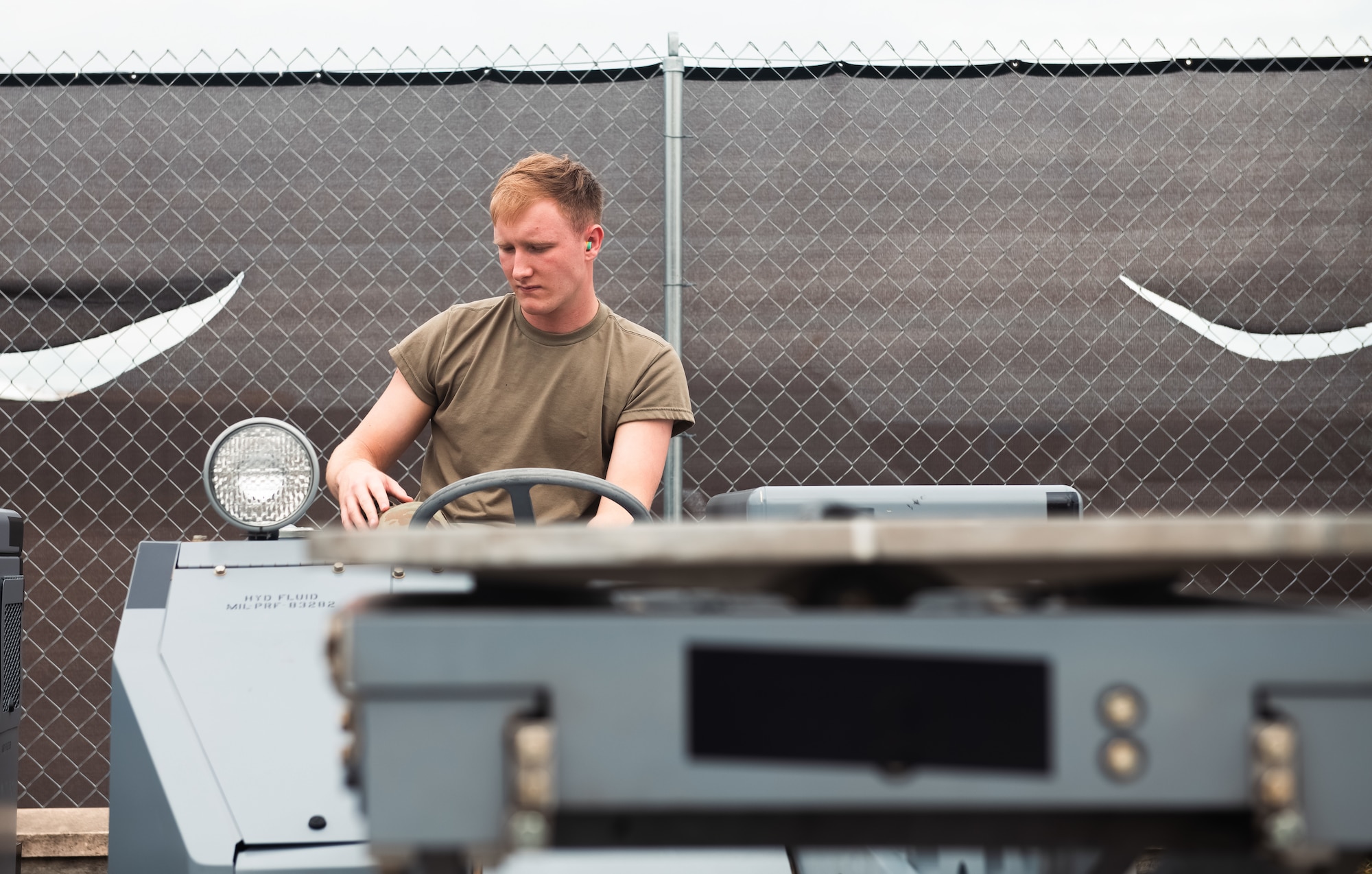 Airmen uses bomb loading cart.