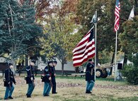 Members of the 114th Regiment, Illinois Volunteer Infantry, Reactivated, march back to the ceremony after firing a 21-rifle salute.