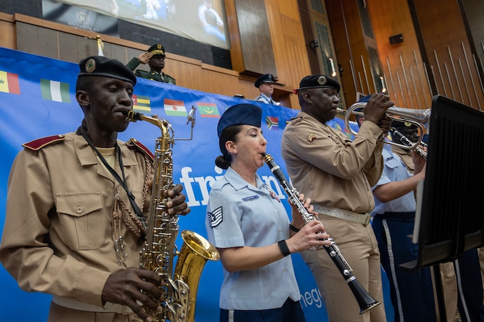 Members of the U.S. Air Forces in Europe Air Forces Africa Band, and the Senegalese Armed Forces Band play the U.S. national anthem during the opening ceremony of the African Air Chiefs Symposium 2023, Feb. 28, 2023, at Dakar, Senegal. The AACS aims to increase the number of partner nations involved in the Association of African Air Forces. AACS seeks to identify key challenges confronting African air chiefs and seeks to strengthen partner networks within Africa by expanding membership of the AAAF. (U.S. Air Force photo by Tech. Sgt. Peter Thompson)