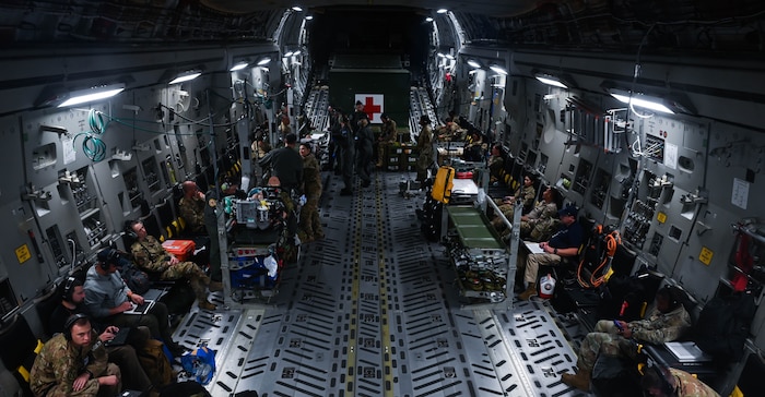 Australian, New Zealand, and U.S. Air Force medical teams work together in flight over Australia on a C-17 Globemaster aircraft during a combined medical interoperability aeromedical evacuation activity as part of Exercise Mobility Guardian 23. MG23 saw Air Mobility Command Airmen work with joint and combined forces, including members of the U.S. Armed Forces and its allies and partners across the Indo-Pacific area of responsibility. (U.S. Air Force photo by Master Sgt. Amy Picard)