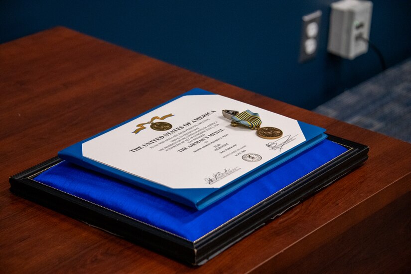 The Airman’s Medal and certificate sit on a table at Joint Base Andrews.