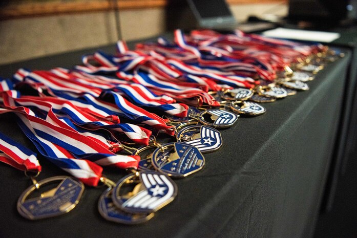 Medals to be presented to staff sergeant selects are displayed on a table during a during the noncommissioned officer (NCO) induction ceremony at Nellis Air Force Base, Nevada, Nov. 2, 2023.