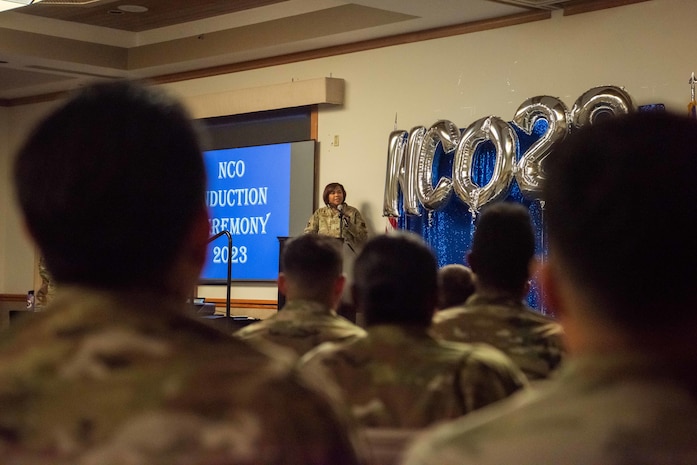 U.S. Air Force Chief Master Sgt. Adrienne Warren, the 99th Air Base Wing command chief, delivers a speech during the noncommissioned officer (NCO) induction ceremony at Nellis Air Force Base, Nevada, Nov. 2, 2023.