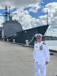 NSA/CSS Chaplain CAPT Winward stands in front of the USS San Jacinto.