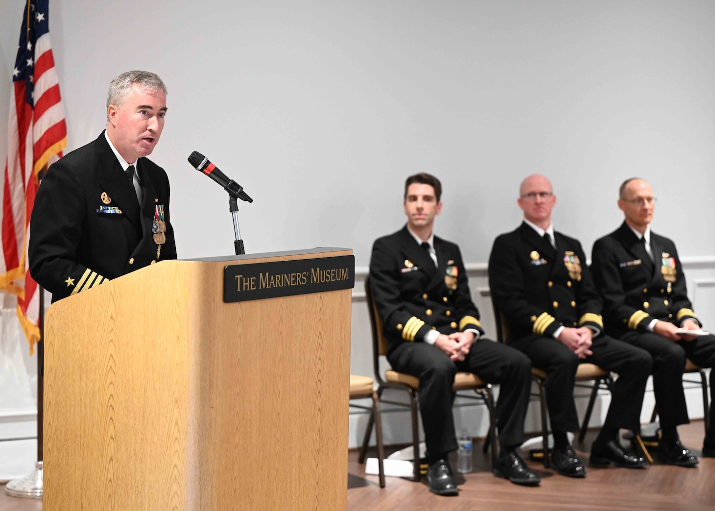 Capt. Brian Hogan, commodore, Submarine Squadron Eight, speaks as the presiding officer during a change of command ceremony for the Los Angeles-class fast-attack submarine USS Columbus (SSN 762) at the Mariner’s Museum and Park in Newport News, Virginia.