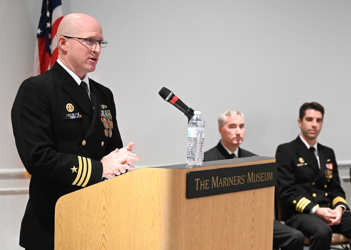 Cmdr. Russell Jones, left, commanding officer of the Los Angeles-class fast-attack submarine USS Columbus (SSN 762), speaks during a change of command ceremony at the Mariner’s Museum and Park in Newport News, Virginia.