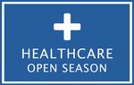 A blue background surrounded by a white rectangle with a medical logo at the top of the blue. In bold print towards the bottom with white coloration it says "Healthcare Open Season"
