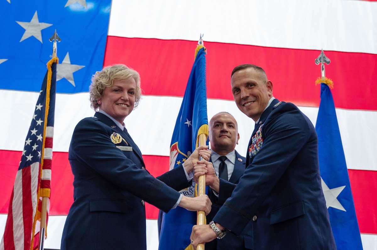Brig. Gen. Melissa Coburn, the 22nd Air Force commander, left, hands the guidon to Col. Samuel Kraemer, the new 934th Airlift Wing commander, at Minneapolis-St. Paul Air Reserve Station, Minnesota, Nov. 4, 2023. Kraemer was previously the commander of the 934th Operations Group. (U.S. Air Force photo by Senior Airman Matthew Reisdorf)