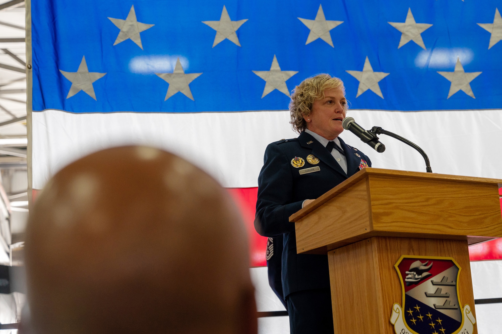 Brig. Gen. Melissa Coburn, the 22nd Air Force commander, speaks to the audience during a 934th Airlift Wing assumption of command ceremony for Col. Samuel Kraemer at the Minneapolis-St. Paul Air Reserve Station, Minnesota, Nov. 5, 2023. Before assuming the command of the 934 AW, Kraemer was the commander of 934th Operations Group. (U.S. Air Force photo by Senior Airman Matthew Reisdorf)
