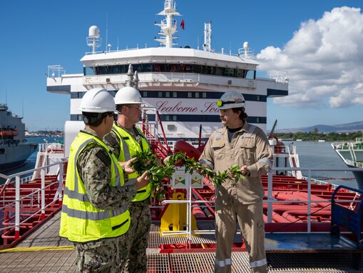 Joint Task Force-Red Hill (JTF-RH) personnel present a maile lei to a merchant tanker Stena Impeccable crewmember on Joint Base Pearl Harbor-Hickam, Hawaii, Nov. 1, 2023.