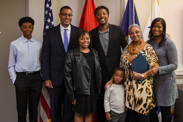 Mr. Franklin Parker, Assistant Secretary of the Navy for Manpower and Reserve Affairs (ASN M&RA) poses with descendants of Mr. Otto Robinson, member of the ‘Philadelphia 15’, after an office call in the Pentagon, Nov. 6, 2023.