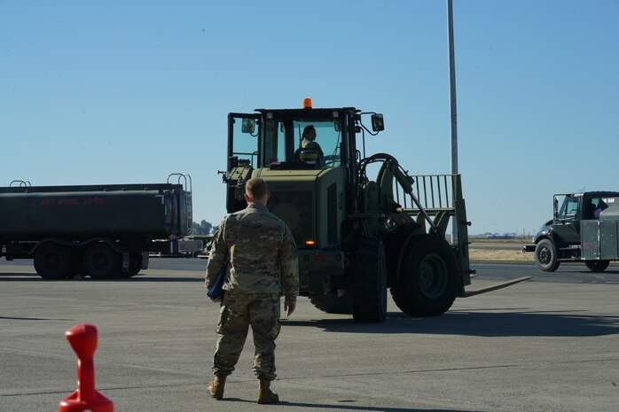 U.S. Air Force Airman 1st Class Monika Mendoza, 9th Operations Support Squadron air traffic controller, drives a 10K All Terrain Materials Handling Forklift while Staff Sgt. Clayton Johnson, 9th Logistics Readiness Squadron fuels mobile distribution supervisor, monitors during the Multi-Capable Airmen Tier-1 course Oct. 26, 2023, at Beale Air Force Base, California.
