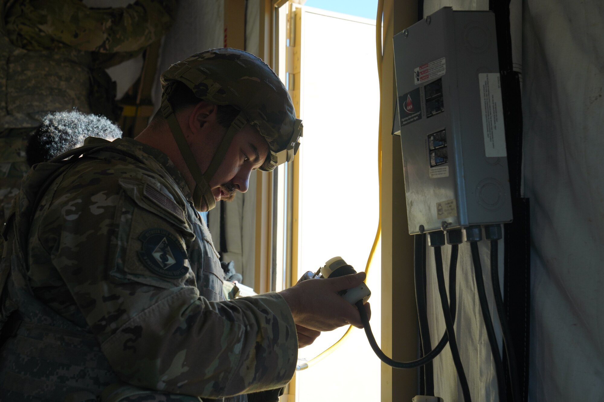 U.S. Air Force Senior Airman Marthinus Coetzee, 9th Physiological Support Squadron launch and recovery team technician, connects the electrical portion of the small shelter system during the Multi-Capable Airmen Tier-1 course Oct. 27, 2023, at Beale Air Force Base, California.