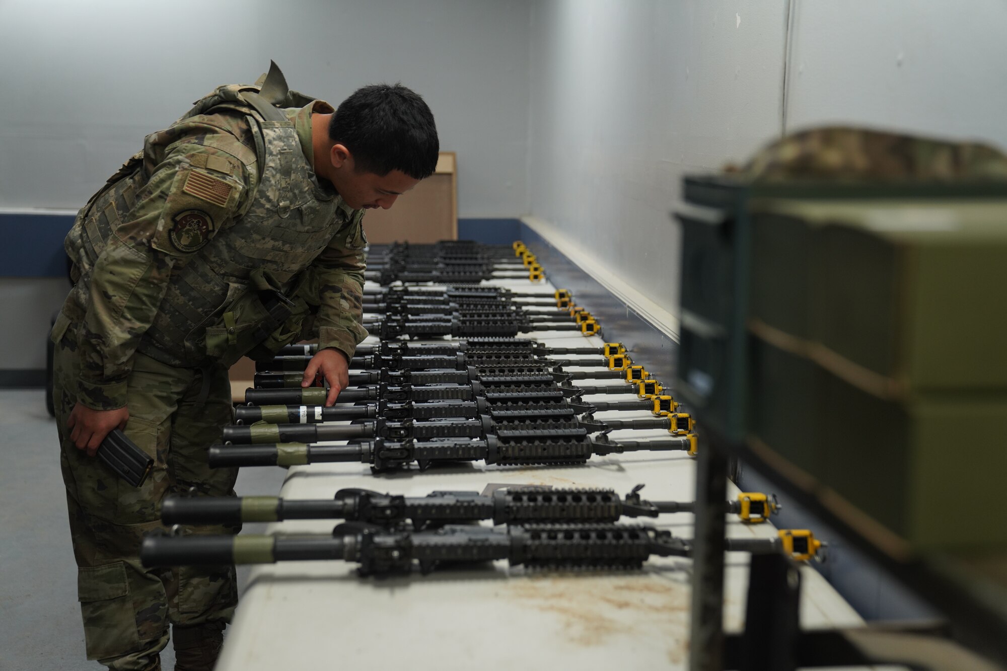 U.S. Air Force Airman 1st Class James Kawai, 9th Logistics Readiness Squadron fuels distribution operator, picks out an M4 during the Multi-Capable Airmen Tier-1 course Oct. 27, 2023, at Beale Air Force Base, California.