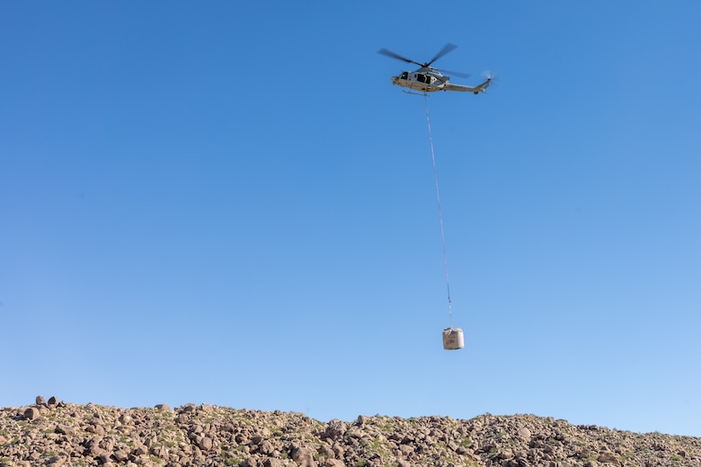 A U.S. Marine Corps UH-1Y Venom with Marine Light Helicopter Attack Training Squadron (HMLAT) 303, Marine Aircraft Group 39, 3rd Marine Aircraft Wing, carries a replacement water guzzler to Harper Canyon located in Anza-Borrego Desert State Park, California, Nov. 5, 2023.