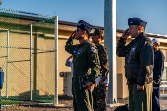 38th Fighter Group commander and 8th Fighter Wing deputy commander render a salute during the opening ceremony of the seventh annual Friendship Day