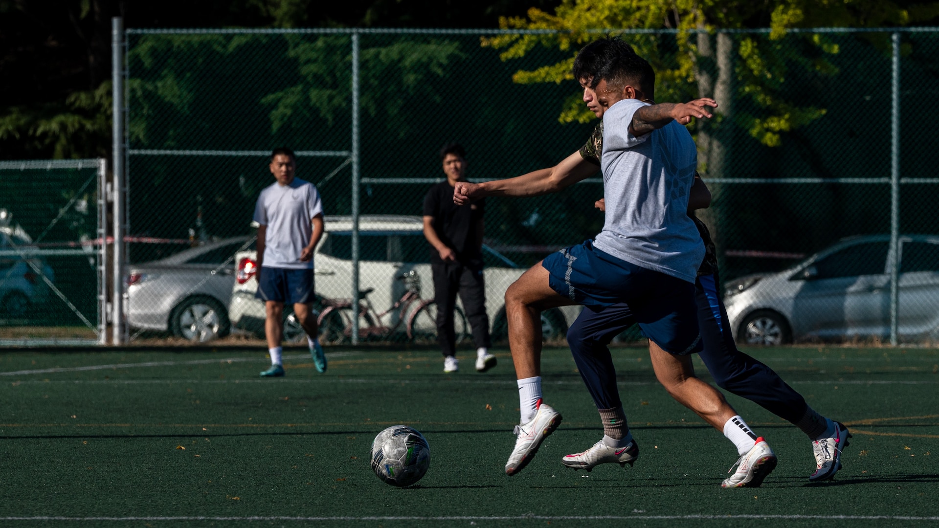 A U.S. Air Force Airman and a Republic of Korea Air Force Airman play for possession of a loose live ball during a soccer exhibition match