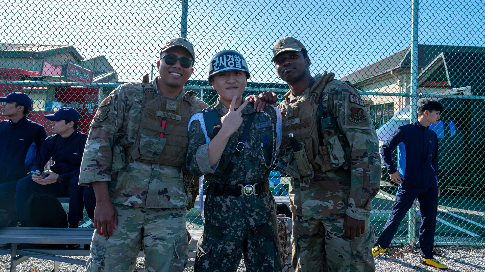 Two U.S. Air Force 8th Security Forces Squadron Airmen stand with a Republic of Korea Air Force 38th Fighter Group military police