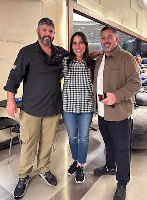 Woman stands between two men