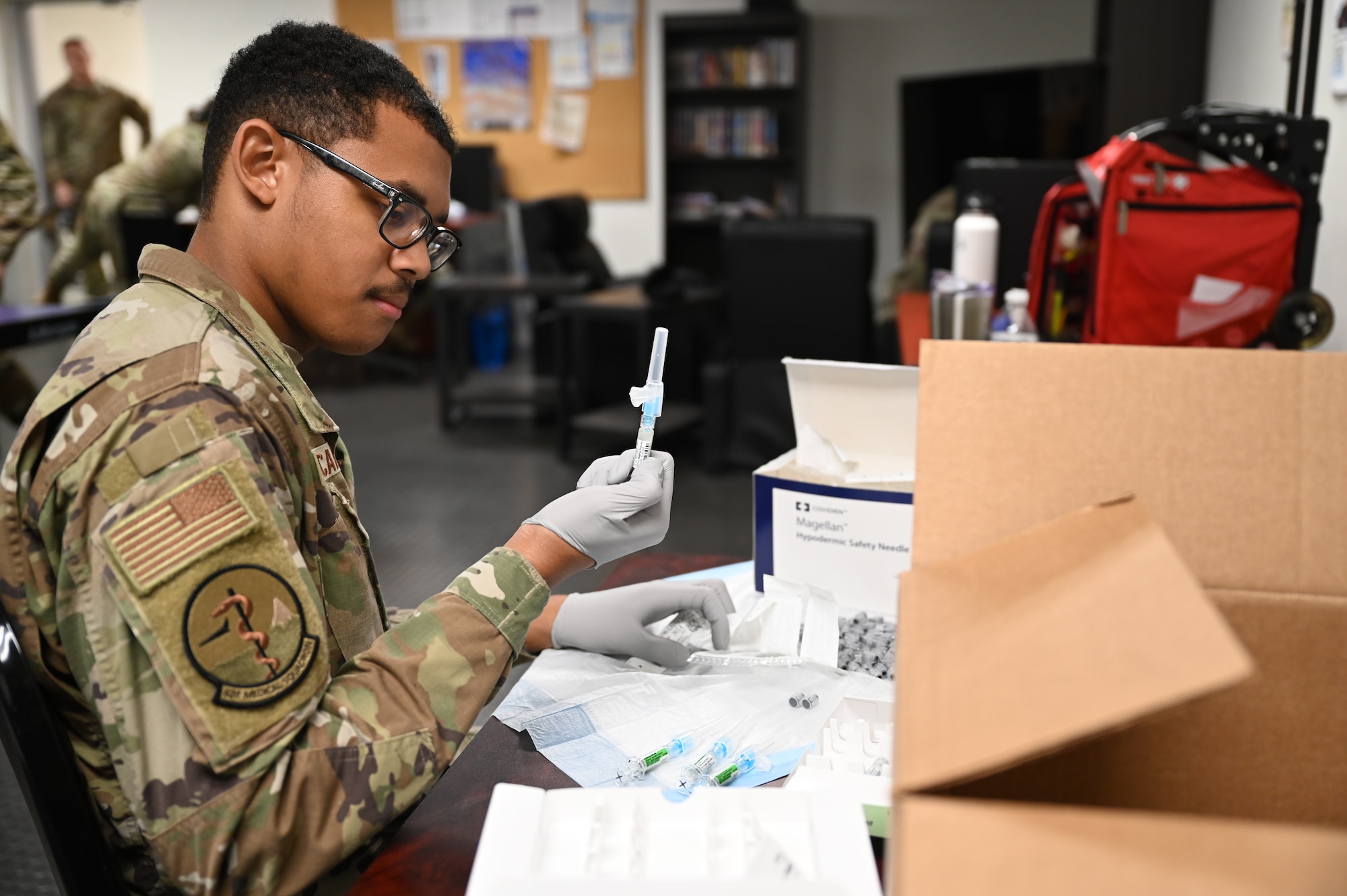 U.S. Air Force Staff Sgt. Kevin Ricard, an aerospace medical technician with the 62d medical squadron, prepares the flu vaccine at Joint Base Lewis-McChord, Wash., Nov. 2, 2023. Service members are required to stay up to date with their vaccinations to avoid mission roadblocks caused by the spread of the flu virus. (U.S. Air Force photo by Airman 1st Class Kylee Tyus)
