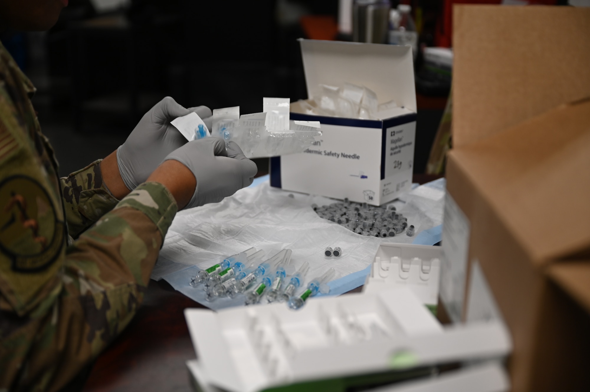 U.S. Air Force Staff Sgt. Kevin Ricard, an aerospace medical technician with the 62d medical squadron, prepares the flu vaccine at Joint Base Lewis-McChord, Wash., Nov. 2, 2023. Service members are required to stay up to date with their vaccinations to avoid mission roadblocks caused by the spread of the flu virus. (U.S. Air Force photo by Airman 1st Class Kylee Tyus)