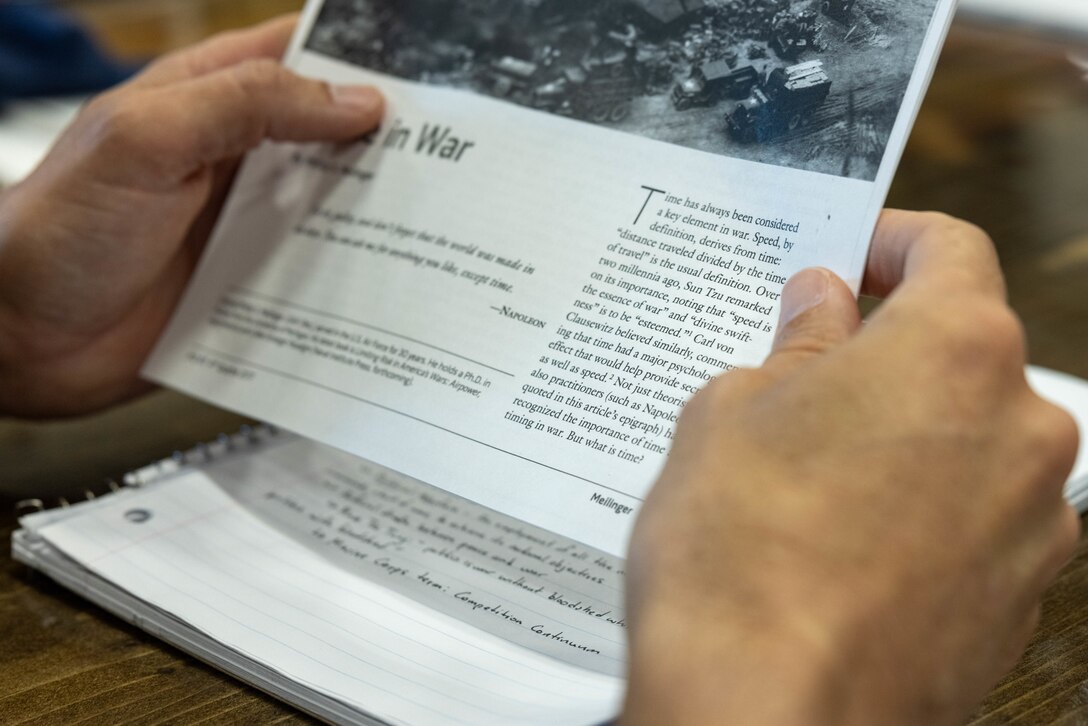U.S. Marine Corps Maj. Adam Bittner, a native of Washington Crossing, Pennsylvania, and an intelligence officer with the I Marine Expeditionary Force Information Group’s reserve detachment reads the publication of Time in War during a familiarization training at Marine Corps Base Camp Pendleton, California, Nov. 2, 2023. During their activation, the Individual Mobilization Augmentee detachment conducted annual training requirements to ensure the reservists can seamlessly transition into I MIG operations during any future activation.  (U.S. Marine Corps photo by Lance Cpl. Macie Ross)
