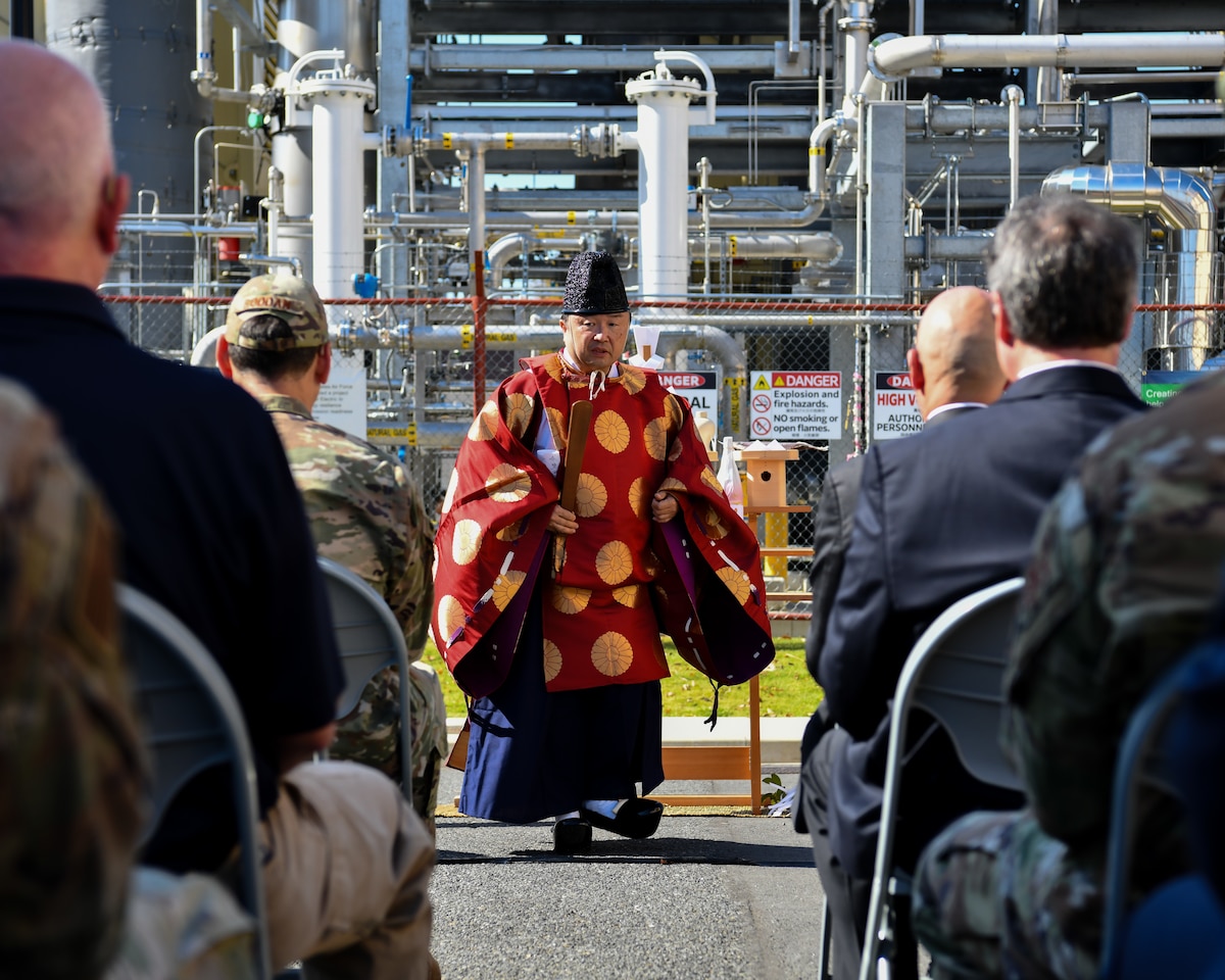 Priest walks to his seat.