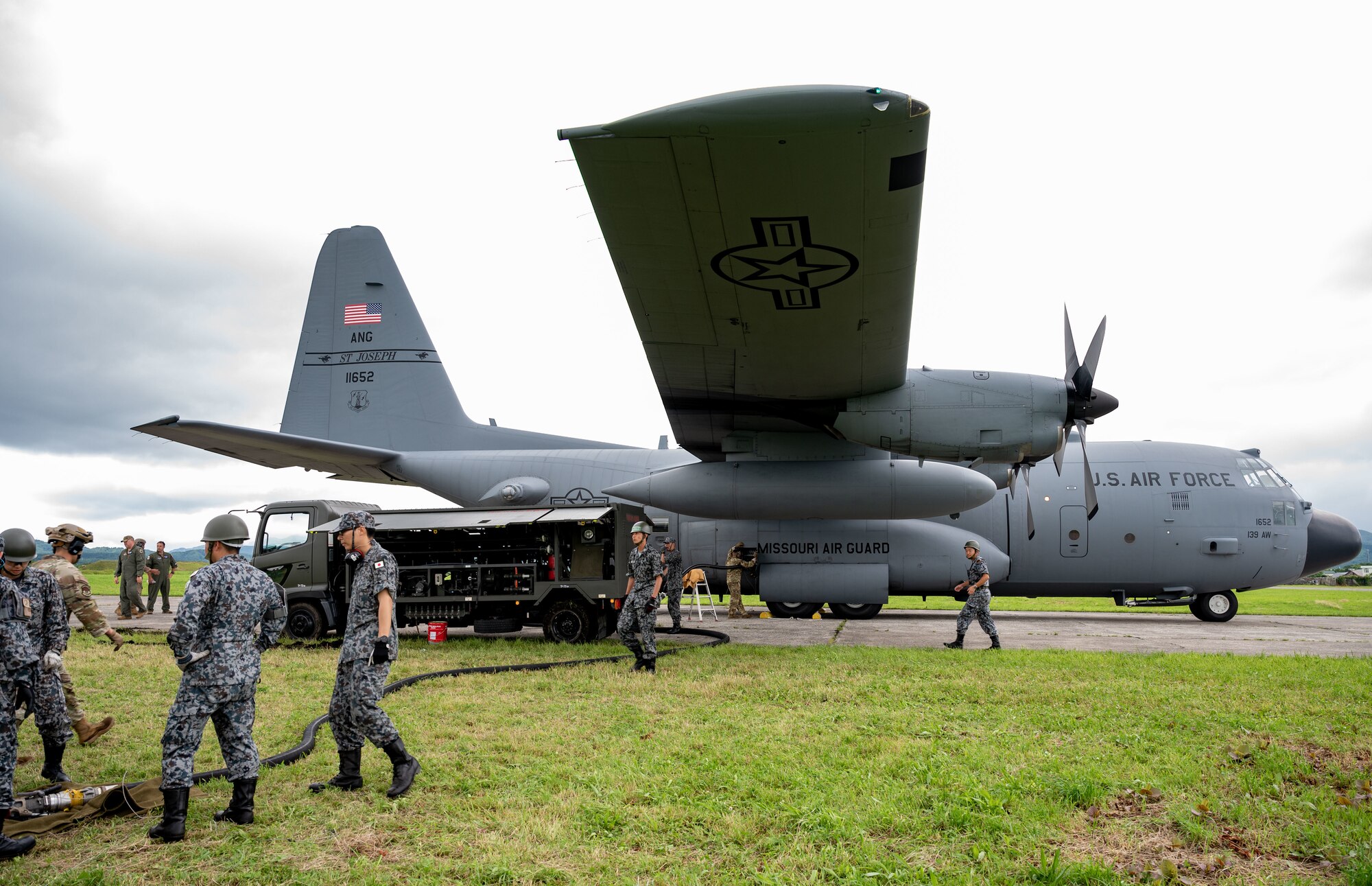 A team of Japanese Air Self-Defense Force members prepare for a specialized fuel operation on a C-130 Hercules in support of Mobility Guardian 2023 at Yakumo sub-base, Japan, July 13, 2023. A multilateral endeavor, MG23 features seven participating countries - Australia, Canada, France, Japan, New Zealand, United Kingdom, and the United States - Operating approximately 70 mobility aircraft across multiple locations spanning a 3,000 miles exercise are from July 5 through July 21.