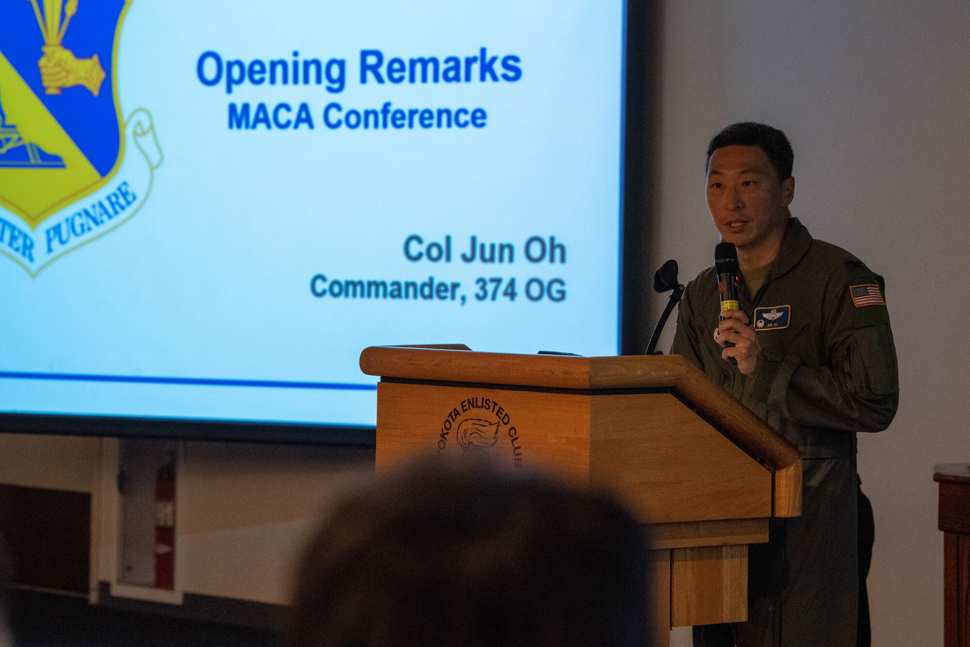A U.S. Air Force pilot delivers opening remarks at a conference.