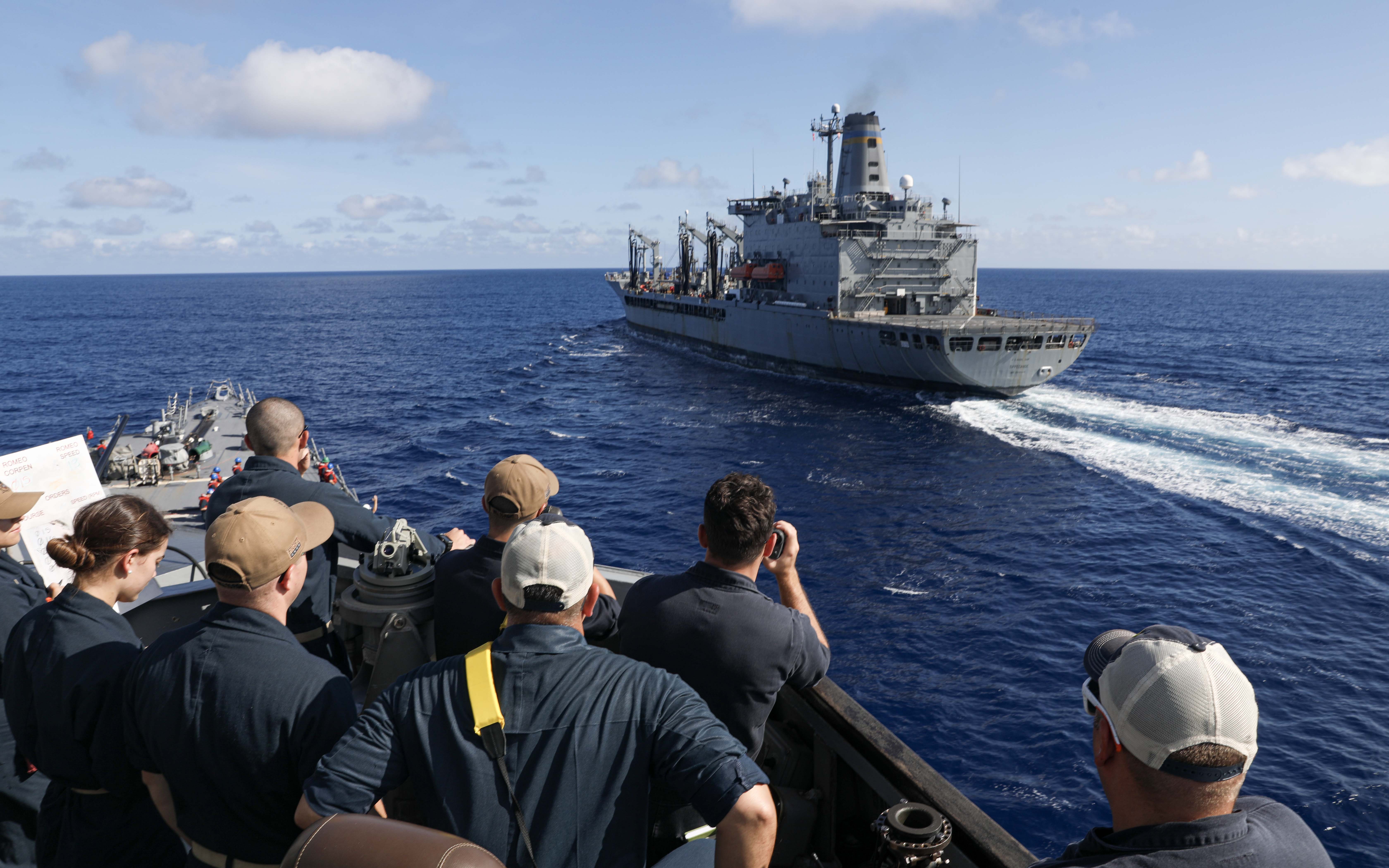 USS Dewey (DDG 105) pulls alongside USNS Tippecanoe (T-AO 199) during an underway replenishment in the South China Sea.