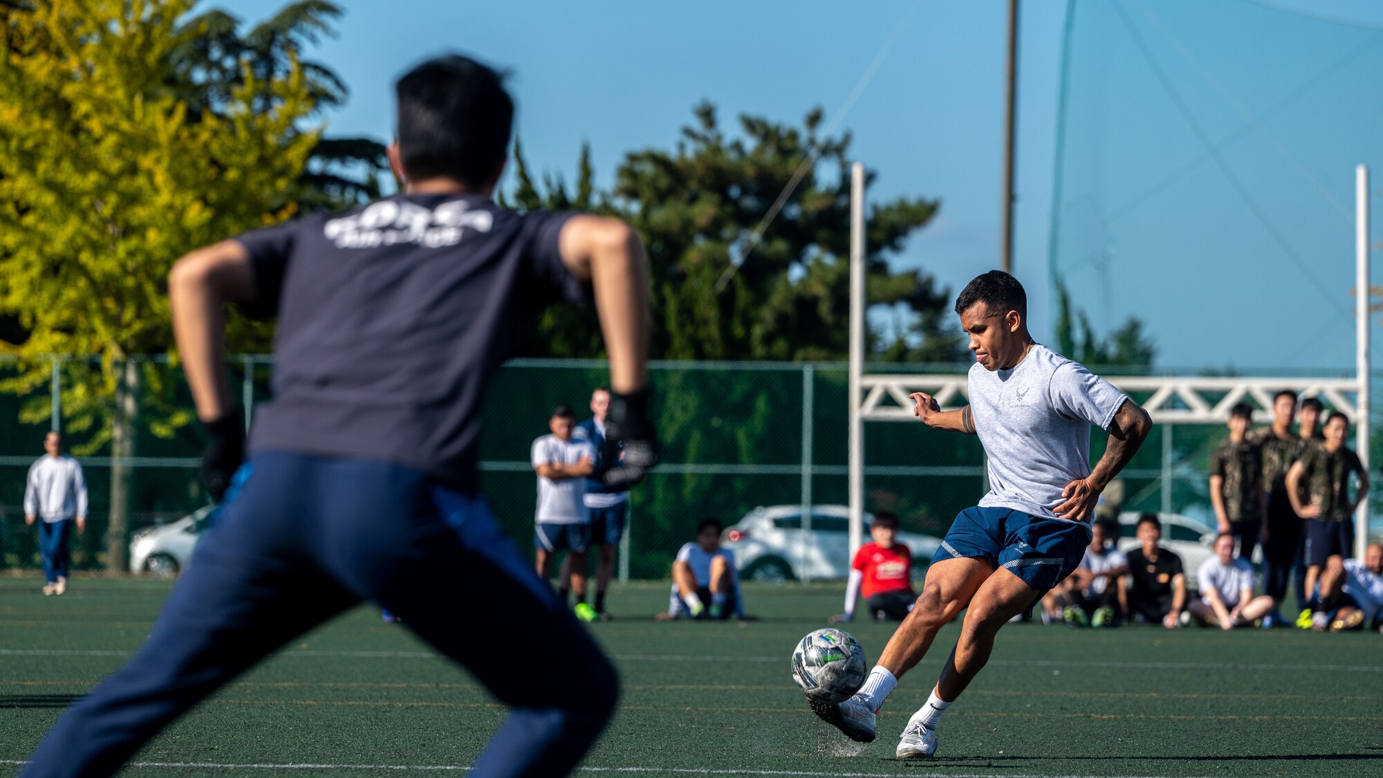 A U.S. Air Force Airman attempts to score a goal during a soccer exhibition match
