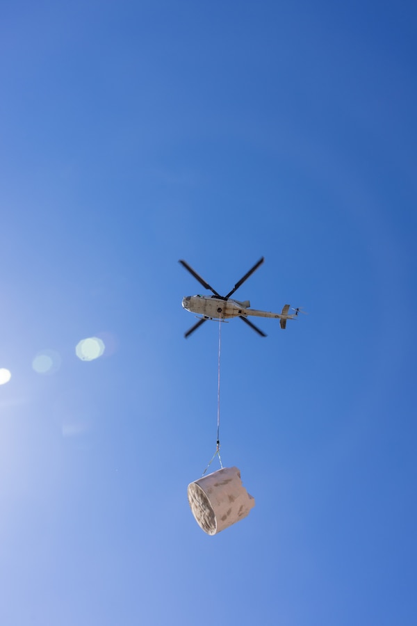 A U.S. Marine Corps UH-1Y Venom with Marine Light Helicopter Attack Training Squadron (HMLAT) 303, Marine Aircraft Group 39, 3rd Marine Aircraft Wing, removes an aging water guzzler from Harper Canyon located in Anza-Borrego Desert State Park, California, Nov. 5, 2023. HMLAT-303 supported state, federal, and private agencies utilizing long-line external lift capabilities of the UH-1Y to replace water guzzlers throughout the park. Guzzlers are self-filling, constructed watering facilities that collect, store, and make water available for wildlife. (U.S. Marine Corps photo by Chief Warrant Officer 2 Trent Randolph)