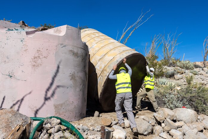 Members of state, federal, and private agencies place a new water guzzler inserted by a U.S. Marine Corps UH-1Y Venom with Marine Light Helicopter Attack Training Squadron (HMLAT) 303, Marine Aircraft Group 39, 3rd Marine Aircraft Wing, at Anza-Borrego Desert State Park, California, Nov. 5, 2023.