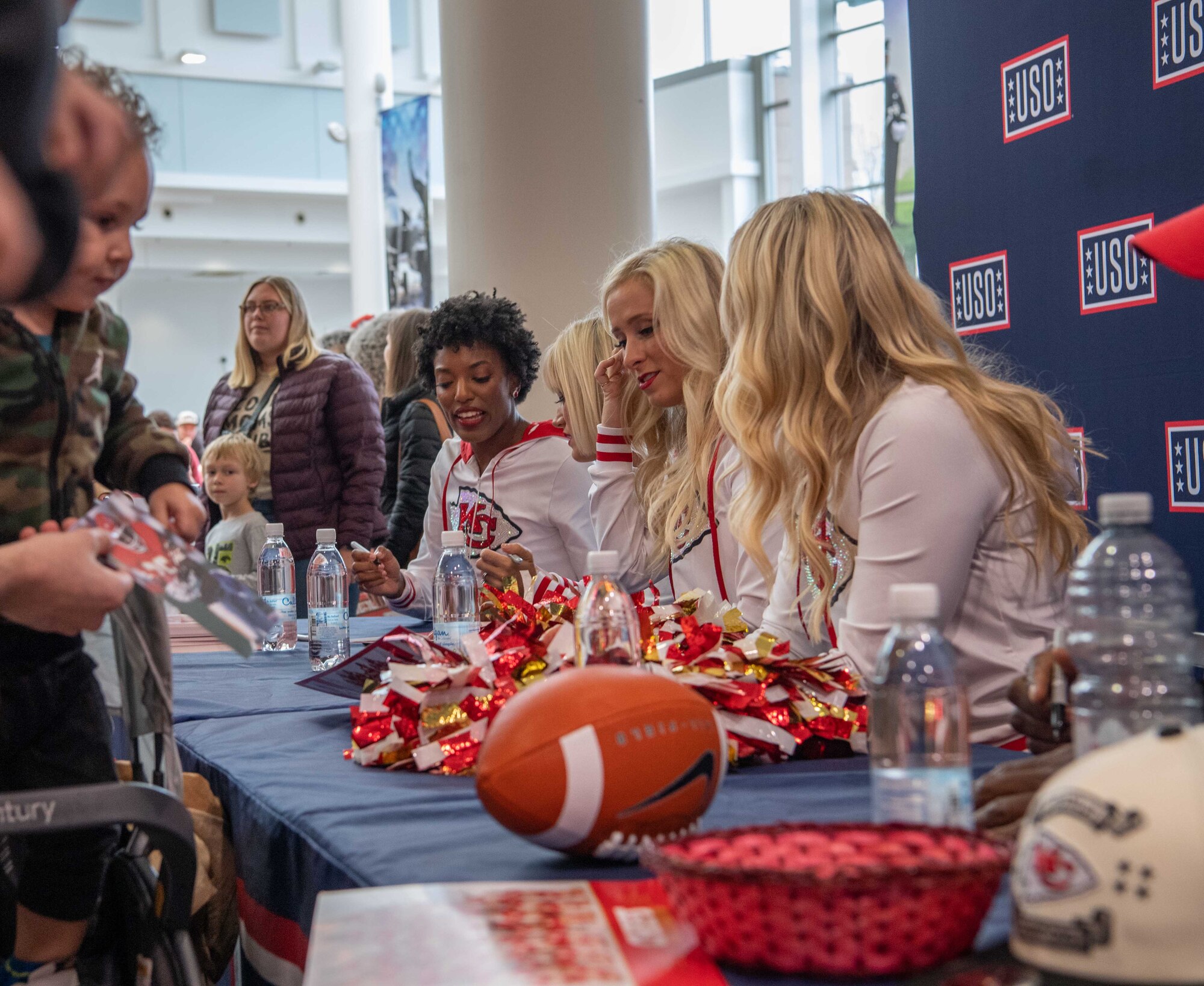 Cheerleaders sit at a table