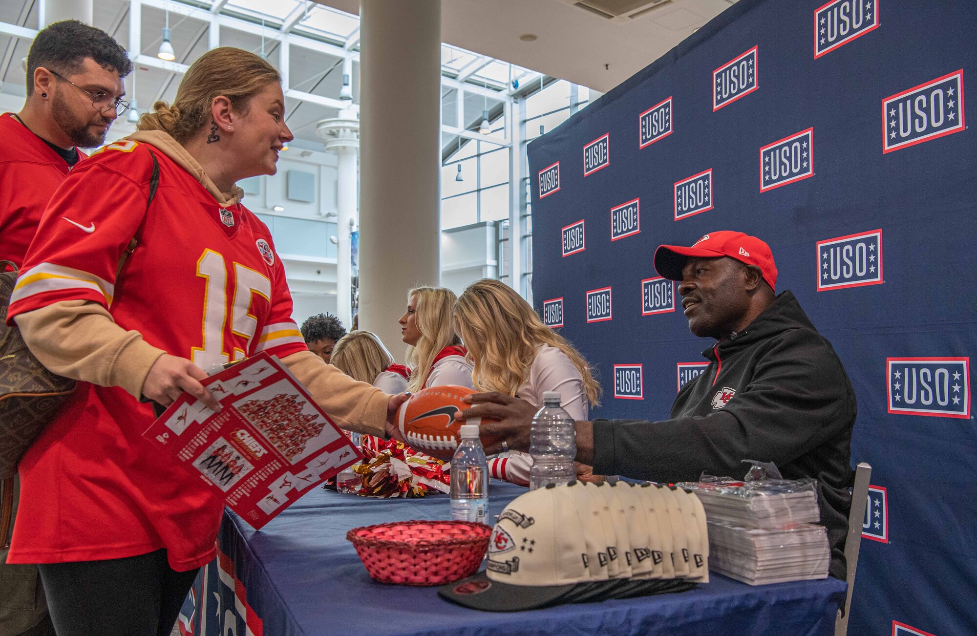 A man hands back a womans signed football