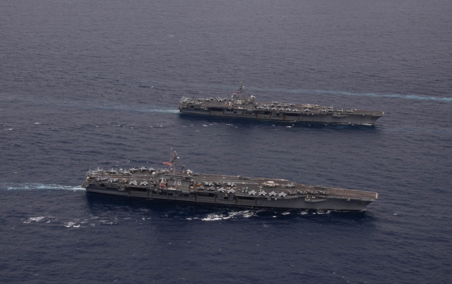 PHILIPPINE SEA (Nov. 7, 2023) Nimitz-class aircraft carriers, USS Ronald Reagan (CVN 76) and USS Carl Vinson (CVN 70), steam in formation during the Multi-Large Deck Exercise (MLDE) in the Philippine Sea, Nov. 7. Ronald Reagan is participating in the bilateral MLDE, which features the ships and aircraft of JMSDF Escort Flotilla 3, as well as the U.S. Navy’s Carrier Strike Group 1 and Carrier Strike Group 5. MLDE is a multi-domain event that grows the already strong partnership and interoperability that exists between the JMSDF and U.S. Navy today. (U.S. Navy photo by Mass Communication Specialist 3rd Class Natasha ChevalierLosada)