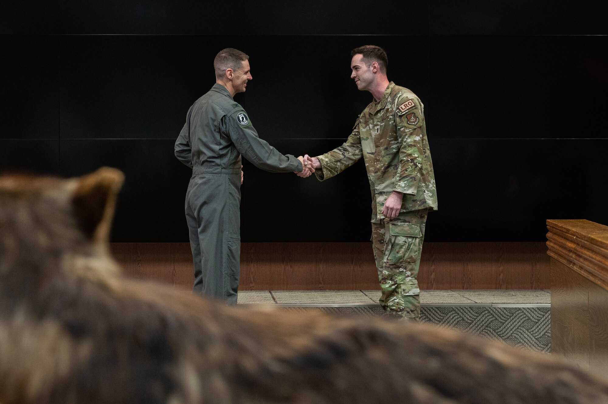 8th Fighter Wing commander presents a coin to 1st Lt. Jeremy Fagan,