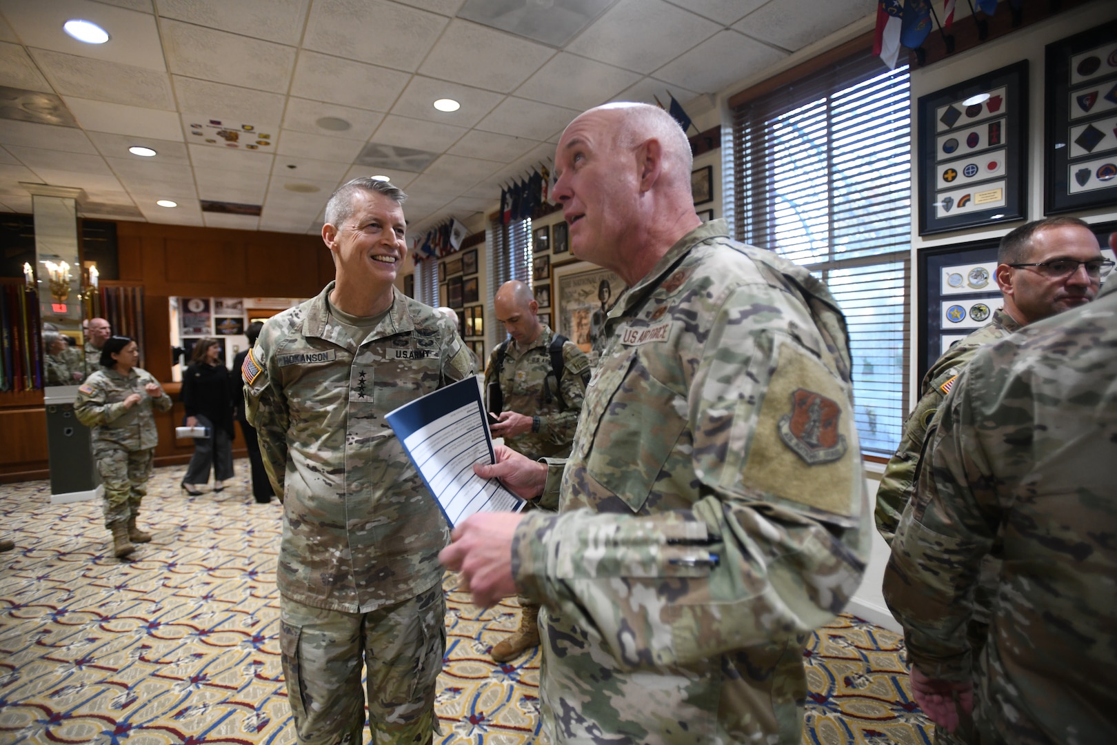 Army Gen. Daniel Hokanson, left, chief of the National Guard Bureau, chats with Air Force Maj. Gen. John P. Hronek, the adjutant general of the Montana National Guard, during the opening ceremony at The 1636 Room at Joint Base Myer-Henderson Hall’s Patton Hall in Arlington, Virginia, Nov. 1, 2023. Named in recognition of the first organized militia in the Massachusetts Bay Colony in 1636 – the predecessor of today’s National Guard – the exhibit space runs the gamut of strategically placed artifacts, framed flags, panel displays, photographs, visual arts and replicated items.