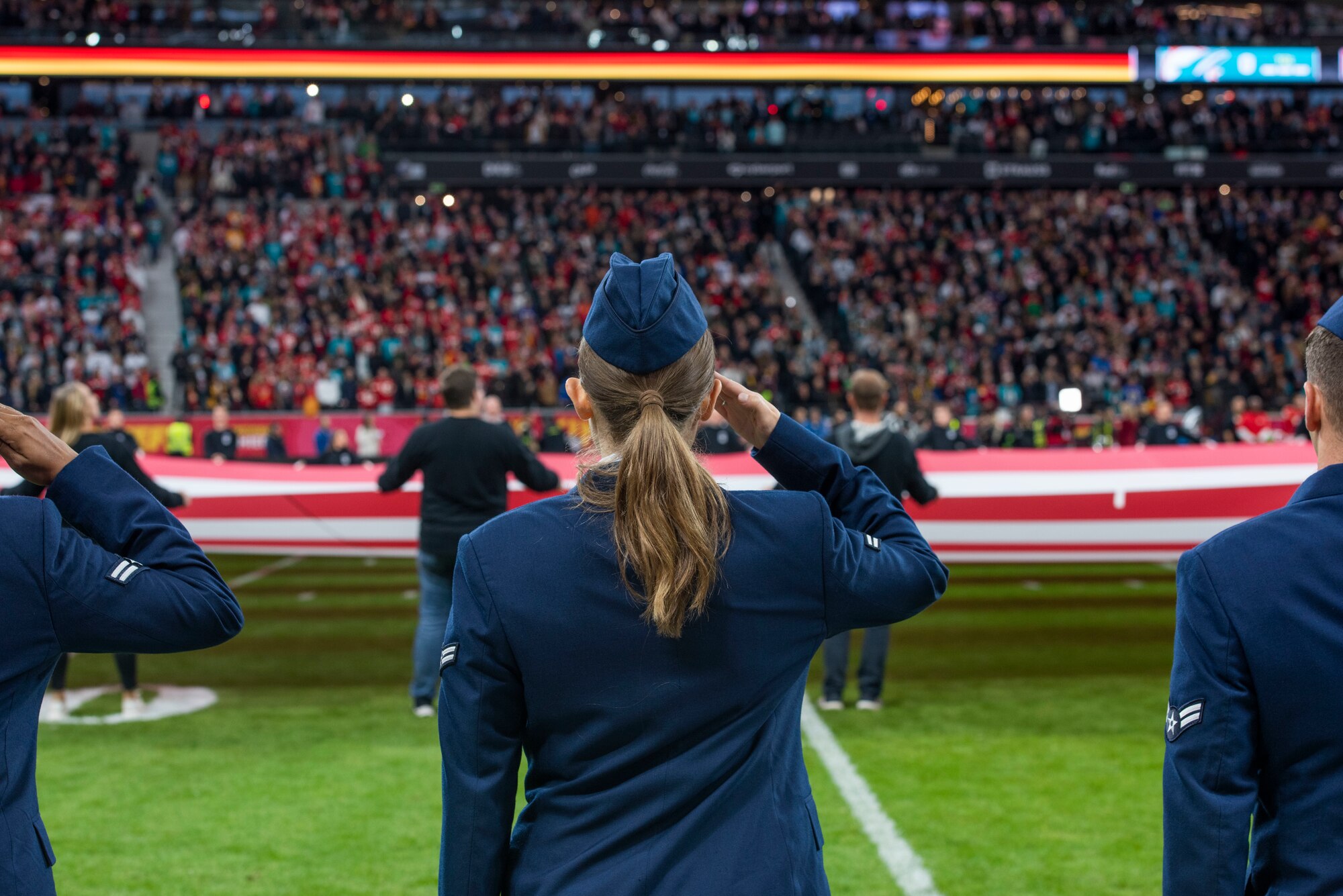 An Airman salutes for the national anthem