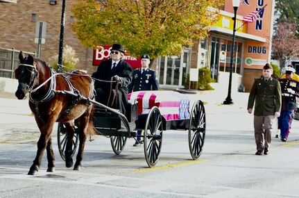 Illinois Army National Guard Sgt. Brent Clark (left) and Private 1st Class Aden Trautvetter march behind the caisson in the Quincy (Illinois) Veterans Day Parade on Nov. 4.