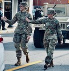 Illinois Army National Guard Cpl. Miah Sally (right) and Private 1st Class Breanne Kidd wave to the crowd during the Quincy (Illinois) Veterans Day Parade on Nov. 4.