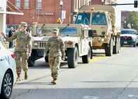 Illinois Army National Guard Cpl. Miah Sally (right) and Private 1st Class Breanne Kidd march in the Quincy (Illinois) Veterans Day Parade on Nov. 4.