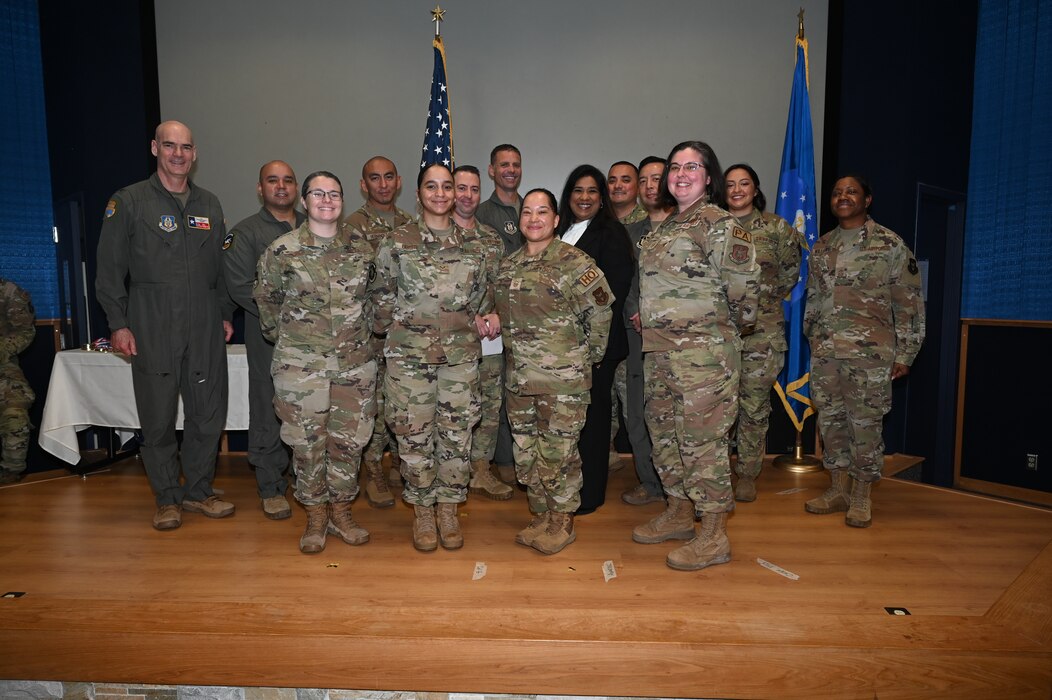 Col. William Gutermuth, 433rd Airlift Wing commander and Chief Master Sgt. Takesha S. William, 433rd AW command chief, pose for a photo with Fiscal Year 2021 annual wing award winners after the awards ceremony at Joint Base San Antonio-Lackland, Texas, Nov. 5, 2023.