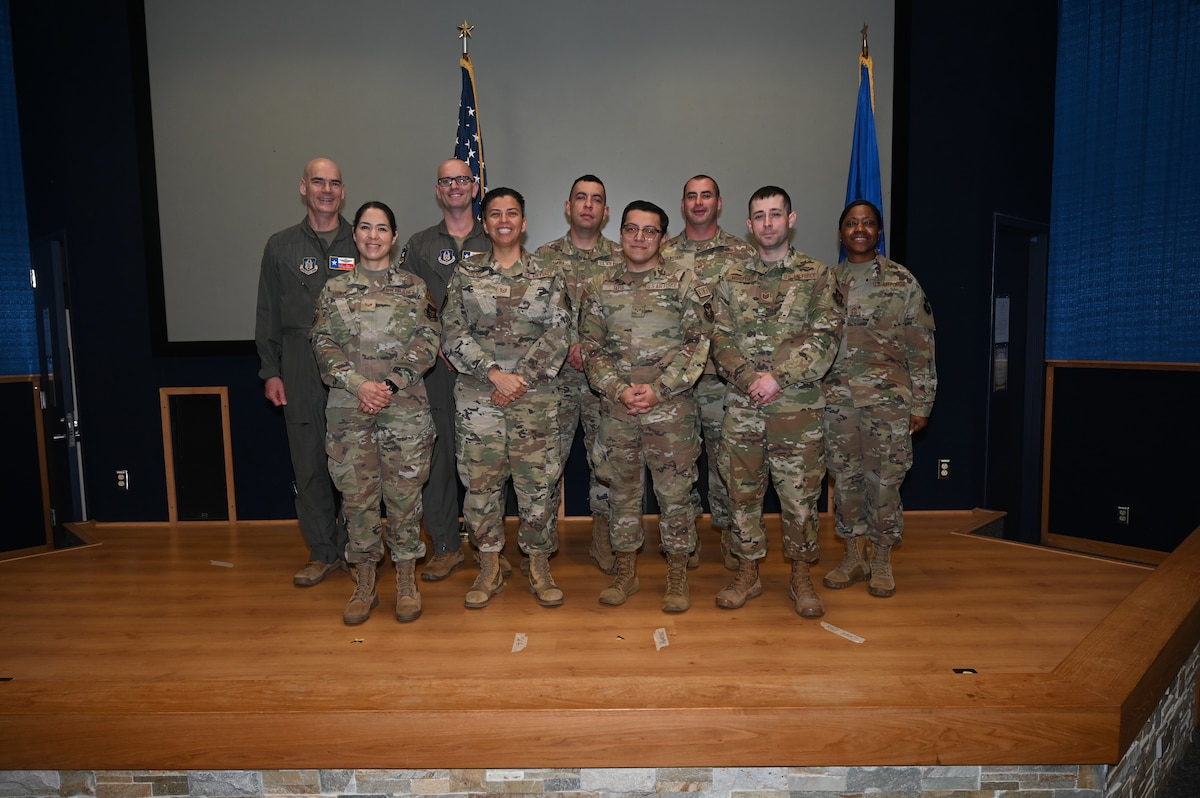 Col. William Gutermuth, 433rd Airlift Wing commander and Chief Master Sgt. Takesha S. William, 433rd AW command chief, pose for a photo with Fiscal Year 2023 annual wing award winners after the awards ceremony at Joint Base San Antonio-Lackland, Texas, Nov. 5, 2023.