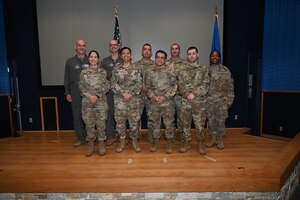 Col. William Gutermuth, 433rd Airlift Wing commander and Chief Master Sgt. Takesha S. William, 433rd AW command chief, pose for a photo with Fiscal Year 2023 annual wing award winners after the awards ceremony at Joint Base San Antonio-Lackland, Texas, Nov. 5, 2023.