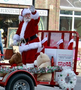 The Marine Corps Toys for Tots Santa Claus waves to the crowd during the Quincy (Illinois) Veterans Day Parade on Nov. 4. Illinois Army National Guard's 126th Quartermaster Co. based in Quincy had military vehicles and multiple Soldiers participate in the annual parade.