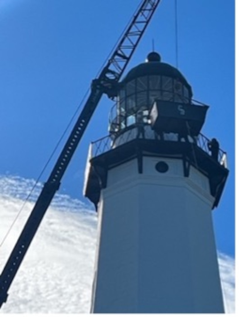 Workers install a Fresnel lens in the light room of the Montauk Lighthouse In Montauk New York. The 3 ½ Order Fresnel lens was created in France in 1903 and has been retrofitted to the Montauk Lighthouse as part of a historical project. (Photo courtesy of the Montauk Historical Society)